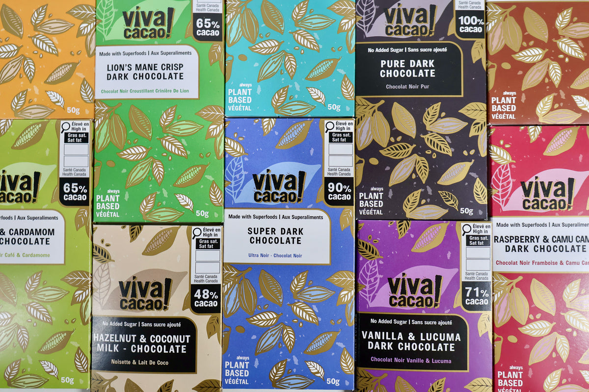 Six Vival Cacao chocolate bars in colorful packaging arranged side by side. The packaging features leaf patterns and labels for different chocolate flavors including Lion's Mane, Super Dark, Hazelnut & Coconut, and Vanilla & Lucuma.