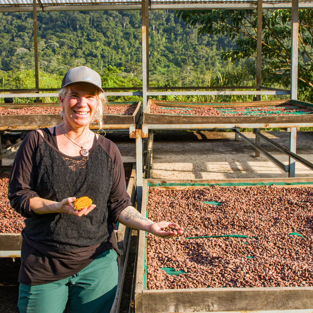 woman with drying cacao pods in peru