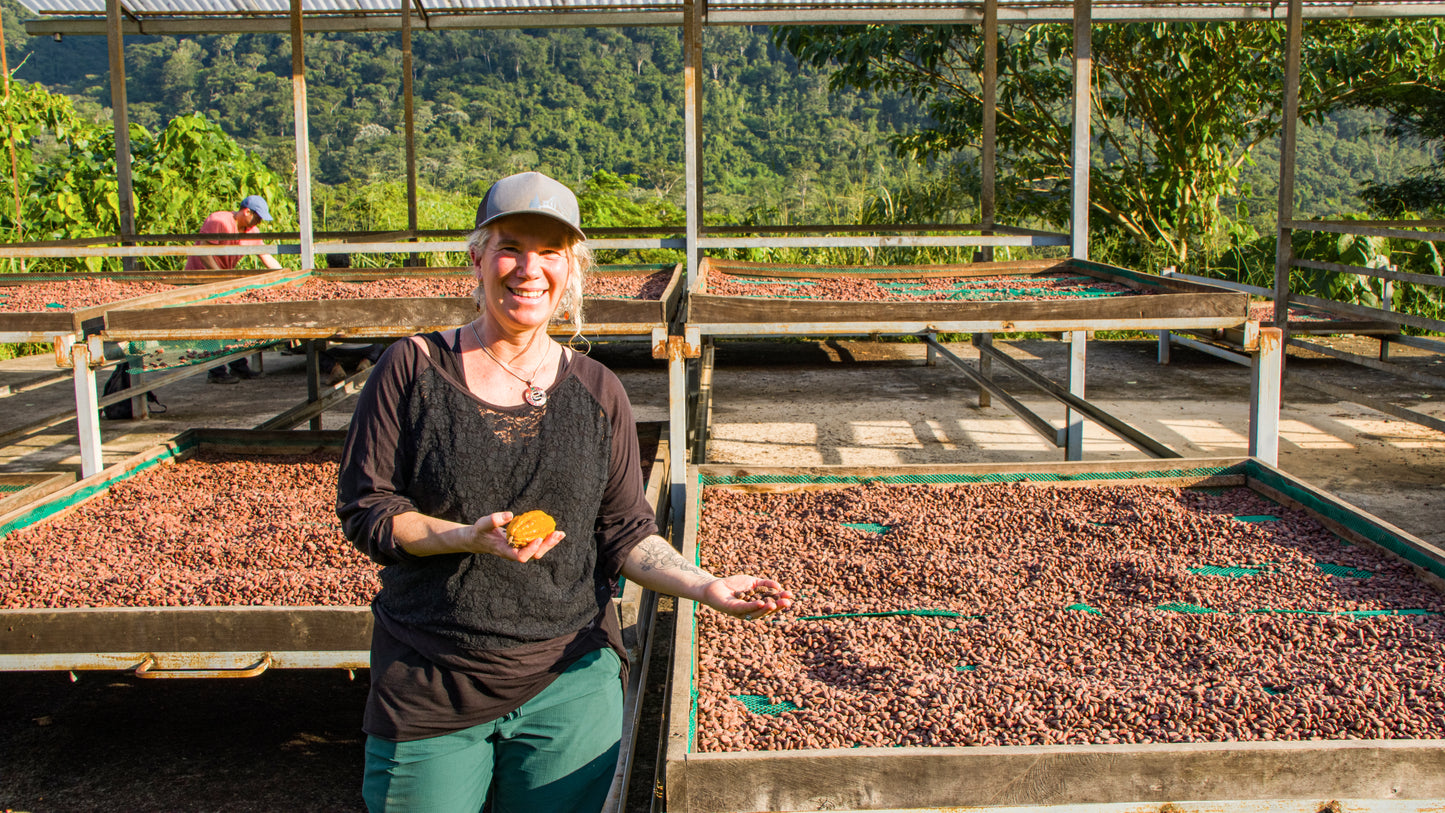 woman with drying cacao pods in peru