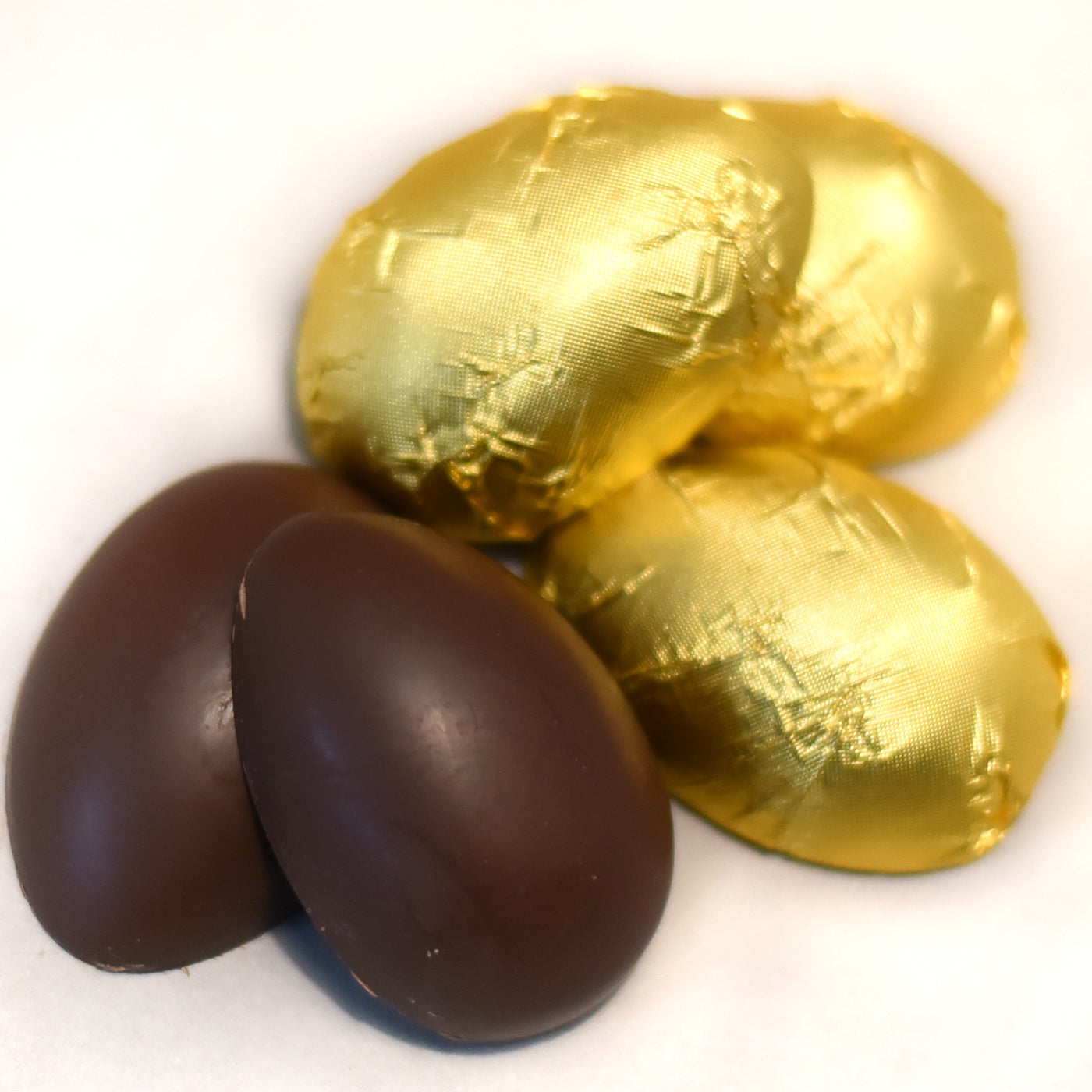 Almond Butter Easter Eggs made with 65% coconut sugar dark chocolate, shown cut open with creamy almond butter inside. Dairy-free and Canadian made treat.